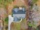 High angle aerial view of the property with the dark roof, long drive and lush lawn, and a stone walkway at 5661 Quail Covey Ln, Wendell, NC 27591