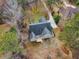 Aerial view of the home featuring a dark roof, light siding, and a deck overlooking the wooded backyard at 5661 Quail Covey Ln, Wendell, NC 27591