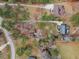 Expansive aerial view of the property showcasing its mature landscaping and surrounding wooded area at 5661 Quail Covey Ln, Wendell, NC 27591