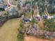 Wide aerial view of a home nestled in a lush, green wooded area, offering a serene and private setting at 5661 Quail Covey Ln, Wendell, NC 27591