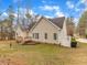 Backyard of the house with a lawn, deck, trees, and privacy fence in the background at 5661 Quail Covey Ln, Wendell, NC 27591