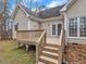 Wooden deck with stairs, offering views of the backyard and surrounding landscape at 5661 Quail Covey Ln, Wendell, NC 27591