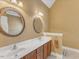 Bathroom featuring a double sink vanity with framed mirrors and cabinet storage at 5661 Quail Covey Ln, Wendell, NC 27591