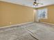 Large bedroom featuring neutral walls, carpet, ceiling fan, and view of outdoors at 5661 Quail Covey Ln, Wendell, NC 27591