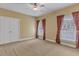 Spacious bedroom with neutral carpet, large closet, and large windows at 5661 Quail Covey Ln, Wendell, NC 27591