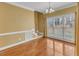 Bright dining room featuring hardwood floors, large windows and a chandelier at 5661 Quail Covey Ln, Wendell, NC 27591