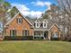 Charming brick home with manicured lawn, mature trees and a welcoming entrance at 5661 Quail Covey Ln, Wendell, NC 27591