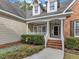Inviting front porch features brick steps, white railings and decorative details at 5661 Quail Covey Ln, Wendell, NC 27591