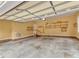 Spacious garage featuring brick trim, storage shelves, and ample open area at 5661 Quail Covey Ln, Wendell, NC 27591