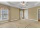 Spacious main bedroom features a tray ceiling, two windows with decorative curtains, and neutral carpet at 5661 Quail Covey Ln, Wendell, NC 27591