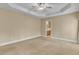 Spacious main bedroom features a tray ceiling, carpet, and an ensuite bathroom at 5661 Quail Covey Ln, Wendell, NC 27591