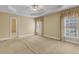 Spacious main bedroom features a tray ceiling, two windows with decorative curtains, and neutral carpet at 5661 Quail Covey Ln, Wendell, NC 27591