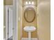Cozy powder room features a pedestal sink, decorative mirror, and stylish lighting fixtures at 5661 Quail Covey Ln, Wendell, NC 27591