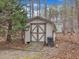 Exterior shot of storage shed with wooden ramp and doors at 5661 Quail Covey Ln, Wendell, NC 27591