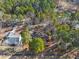 An aerial view of a home nestled among trees in a wooded neighborhood with well-maintained landscaping at 573 Broadmoor Ct, Sanford, NC 27332