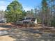 Aerial view of home showing back deck and large lot surrounded by mature trees at 573 Broadmoor Ct, Sanford, NC 27332