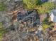 Overhead view of a home with a dark roof surrounded by trees at 573 Broadmoor Ct, Sanford, NC 27332