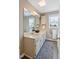 Bright bathroom with a double vanity, large mirror, and stylish fixtures and finishes at 573 Broadmoor Ct, Sanford, NC 27332