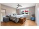 Bright bedroom with wood floors, ceiling fan, and a window offering a view of the outdoors at 573 Broadmoor Ct, Sanford, NC 27332