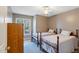 Charming bedroom with two beds, wood furniture, and a window overlooking the peaceful outdoors at 573 Broadmoor Ct, Sanford, NC 27332