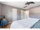 Neutral-toned bedroom featuring a comfortable bed, ceiling fan, and ample natural light from a window at 573 Broadmoor Ct, Sanford, NC 27332