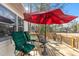 Charming outdoor deck with a red umbrella and comfortable seating overlooking a serene landscape at 573 Broadmoor Ct, Sanford, NC 27332