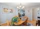 Bright dining room with hardwood floors, chandelier, and an open layout at 573 Broadmoor Ct, Sanford, NC 27332