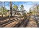 Quaint single story home with mature trees and front walkway at 573 Broadmoor Ct, Sanford, NC 27332