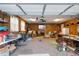 Spacious garage with wood paneling, overhead lighting, and plenty of room for storage and hobbies at 573 Broadmoor Ct, Sanford, NC 27332