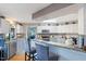 Bright kitchen featuring granite counters, two-tone cabinets, stainless steel appliances, and a breakfast bar at 573 Broadmoor Ct, Sanford, NC 27332