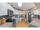Updated kitchen with granite countertops, stainless steel appliances, and wooden floors at 573 Broadmoor Ct, Sanford, NC 27332