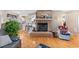 Cozy living room with a brick fireplace, hardwood floors, and access to the kitchen at 573 Broadmoor Ct, Sanford, NC 27332