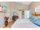 Neutral main bedroom boasts vaulted ceiling and a dresser with double doors leading to bathroom at 573 Broadmoor Ct, Sanford, NC 27332