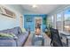 Relaxing sunroom with blue accent walls, lots of windows, and hardwood flooring at 573 Broadmoor Ct, Sanford, NC 27332