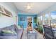 Comfortable sunroom with blue walls, large windows, and a cozy seating area at 573 Broadmoor Ct, Sanford, NC 27332