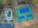 Aerial view of community tennis and pickle ball courts next to a pool and clubhouse at 573 Broadmoor Ct, Sanford, NC 27332