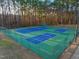 Community tennis courts with green fencing, mature trees, and shade at 573 Broadmoor Ct, Sanford, NC 27332