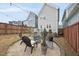 Well-maintained backyard with a fire pit, chairs, landscaping, and string lights, perfect for outdoor gatherings at 656 Groveview Wynd, Wendell, NC 27591