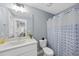 The bathroom features a modern sink vanity, toilet, decorative shower curtain, and modern lighting at 656 Groveview Wynd, Wendell, NC 27591