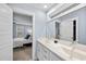 Bright bathroom boasts a double sink vanity with white cabinets and a view to the bedroom at 656 Groveview Wynd, Wendell, NC 27591