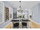 Elegant dining room with stylish chandelier and views into kitchen at 656 Groveview Wynd, Wendell, NC 27591