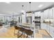 Open concept kitchen with a large island, stainless steel appliances, and a view of the dining room at 656 Groveview Wynd, Wendell, NC 27591
