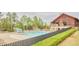 Community pool with a slide, lounge chairs, a pavilion, and beautiful landscaping for summer fun at 656 Groveview Wynd, Wendell, NC 27591