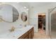 Bathroom featuring double sinks, quartz countertop, and walk-in closet at 702 Great Eno Path, Hillsborough, NC 27278