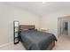 Comfortable bedroom featuring carpeted floors and a queen bed with contemporary lighting at 702 Great Eno Path, Hillsborough, NC 27278