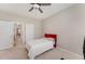 Neutral bedroom featuring a bed, ceiling fan, and adjacent hallway at 702 Great Eno Path, Hillsborough, NC 27278