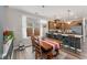 Dining room flows into the open kitchen featuring a wooden table and a large window at 702 Great Eno Path, Hillsborough, NC 27278