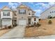 Charming two-story townhome with a one-car garage, landscaped front yard and brick accents at 702 Great Eno Path, Hillsborough, NC 27278