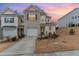 Charming two-story home with a brick facade, attached garage, and manicured lawn at 702 Great Eno Path, Hillsborough, NC 27278