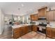 Modern kitchen with stainless steel appliances, quartz countertops and dark wood cabinets at 702 Great Eno Path, Hillsborough, NC 27278